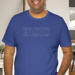 May include: A royal blue t-shirt with a white outline of the word "BASIC" on the front.