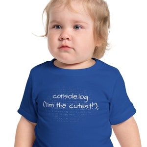 May include: A toddler wearing a royal blue t-shirt with the text "console.log('I'm the cutest!');" printed in white.