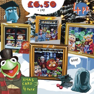 May include: A 4-pack of Christmas cards featuring Muppet characters in scenes inspired by A Christmas Carol. The cards are framed in gold and display various Muppets including Kermit, Miss Piggy, and Gonzo. Text includes "MARLEY", "25 MARLEY &", "XMAS CARD 4 PACK", "Boo!", and "4 PK".