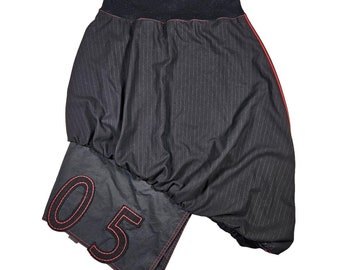 May include: A black and white striped skirt with a red trim and a black patch with the number "05" embroidered in red.
