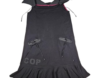 May include: Black sleeveless dress with a ruffled hem and two pockets on the front. The dress has a black and red trim around the neckline and the word "COP" printed on the front.