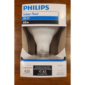 May include: A Philips BR30 indoor flood light bulb in its original packaging. The packaging is white and blue with the Philips logo and product information. The bulb is 65w and has a brightness of 620 lumens.