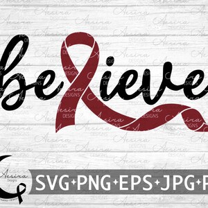 May include: A black and white graphic design with the word "believe" in a cursive font. A red ribbon is behind the word. The design is on a white wood background.