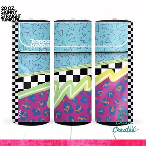 May include: A 20 oz. skinny straight tumbler with a retro 80s design. The tumbler features a teal background with purple triangles and zigzags, a black and white checkered pattern, and a pink leopard print. The text "Trapper Keeper" is visible.