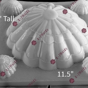 May include: A white plastic mold for making jello desserts. The mold is shaped like a large flower with four smaller flower-shaped molds around it. The mold is 11.5 inches wide and 4 inches tall.