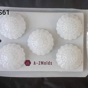 May include: A clear plastic mold with five round cavities, each with a raised floral design. The mold is labeled "S61" and "A-Z Molds".