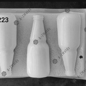 May include: A white silicone mold with three cavities shaped like glass bottles. The mold is labeled "S223" and "A-ZMolds".