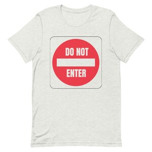 May include: A white t-shirt with a red and white "Do Not Enter" sign printed on the front.