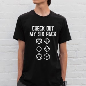 May include: A black t-shirt with the text "CHECK OUT MY SIX PACK" and a graphic of six dice.