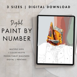 May include: Digital paint by number image of a green and yellow frog on a branch. The image is displayed on a tablet screen with a stylus nearby. The text "Digital Paint by Number" is displayed above the image.