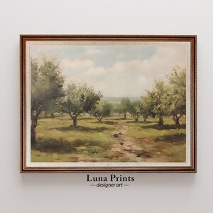 May include: A framed painting of a landscape with a dirt path leading through a field of trees. The trees are green and the sky is blue with white clouds. The painting is in a brown frame with a gold trim.