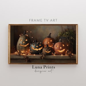 May include: A framed print featuring five carved pumpkins with lit-up faces, surrounded by string lights and autumn leaves. The pumpkins are in shades of orange and black. The text "FRAME TV ART" and "Luna Prints designer art" are visible.