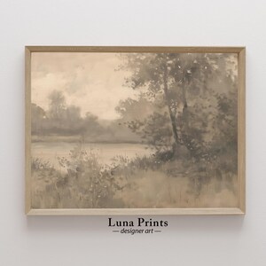 May include: A framed watercolor painting of a misty lake scene with trees and foliage in shades of gray and brown. The painting has a soft, ethereal feel and evokes a sense of tranquility.