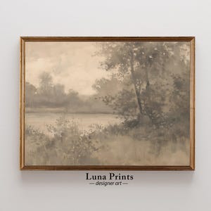 May include: A framed watercolor painting of a misty landscape with a lake and trees in shades of gray and brown.