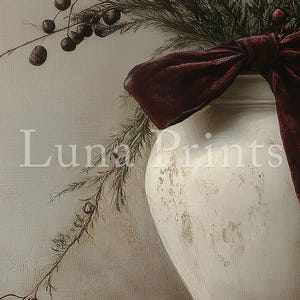 May include: A white ceramic vase with a distressed finish, decorated with a burgundy velvet bow and sprigs of greenery with small brown berries.
