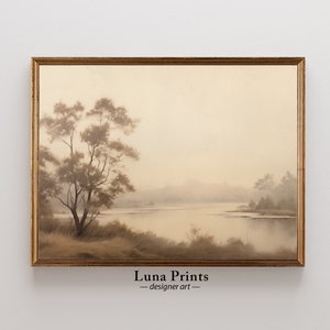 May include: A framed painting depicting a misty lake scene with a solitary tree in the foreground. The painting is rendered in muted shades of brown and beige.