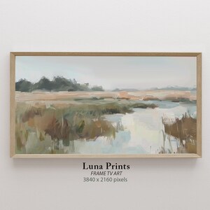 May include: A framed painting depicting a landscape with a river meandering through a field of tall grass. The sky is a soft blue and the water is a light blue. The grass is a mix of green and brown. The painting is in a light wood frame.