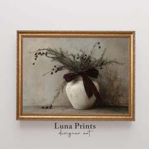 May include: A framed print of a still life featuring a white ceramic vase with a burgundy velvet bow, filled with dried branches with small brown berries. The background is a muted gray.