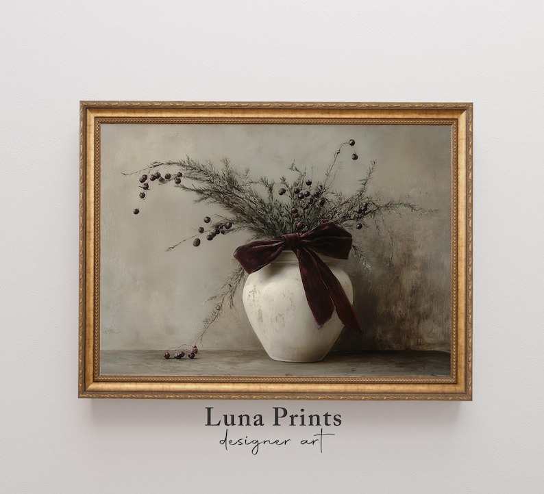 May include: A framed print of a still life featuring a white ceramic vase with a burgundy velvet bow, filled with dried branches with small brown berries. The background is a muted gray.
