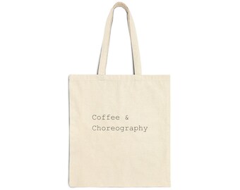 May include: Cream-colored tote bag with the words "Coffee & Choreography" printed in black. The bag has a rectangular shape with a handle made of the same material. The background is plain white.