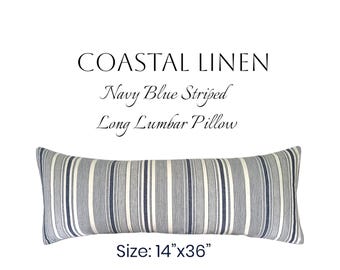 May include: A long lumbar pillow with navy blue and white stripes. The pillow is rectangular and measures 36 cm by 91 cm. The text "COASTAL LINEN Navy Blue Striped Long Lumbar Pillow" is displayed above the pillow.