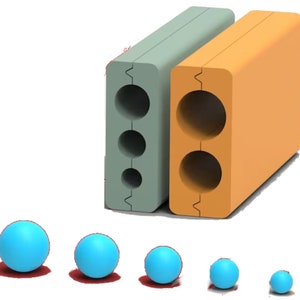 May include: Five blue balls of different sizes, arranged from largest to smallest, in front of two rectangular blocks. The blocks are made of a light green and orange material and have circular holes cut out of them.