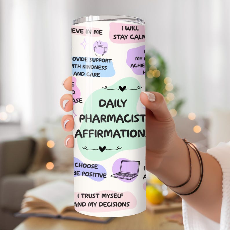 May include: A white tumbler with a colorful design featuring affirmations for pharmacists. The text includes "Daily Pharmacist Affirmation", "I Will Stay Calm", "Provide Support With Kindness and Care", "Choose to Be Positive", and "I Trust Myself and My Decisions".