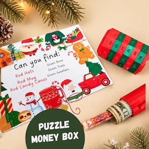 May include: A Christmas-themed activity card with the text Can you find: Red Hats, Red Mug, Red Candy Canes, Green Bows, Green Trees, Green Sweaters. Beside it is a red and green cylindrical combination lock puzzle and a red money holder tube.