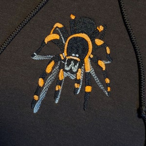 Brown hoodie with embroidered tarantula glow in the dark fluorescent design