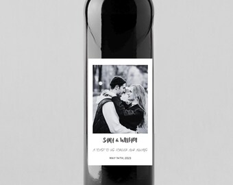May include: A black and white photograph of a couple on a wine bottle label. The label reads "Sara & William, A toast to us forever and always, May 14th, 2023".