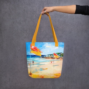 May include: A yellow tote bag with a beach scene printed on it. The scene features a blue sky, white clouds, a sandy beach, and people in the water. There are also two yellow and red flags on the beach.