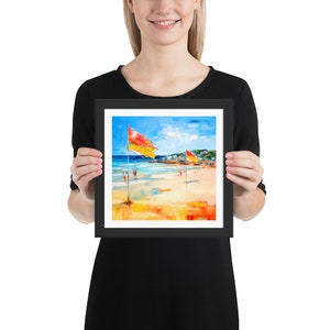 May include: Framed painting of a beach scene with two red and yellow flags, blue water, and a sandy beach. The painting is in a black frame.
