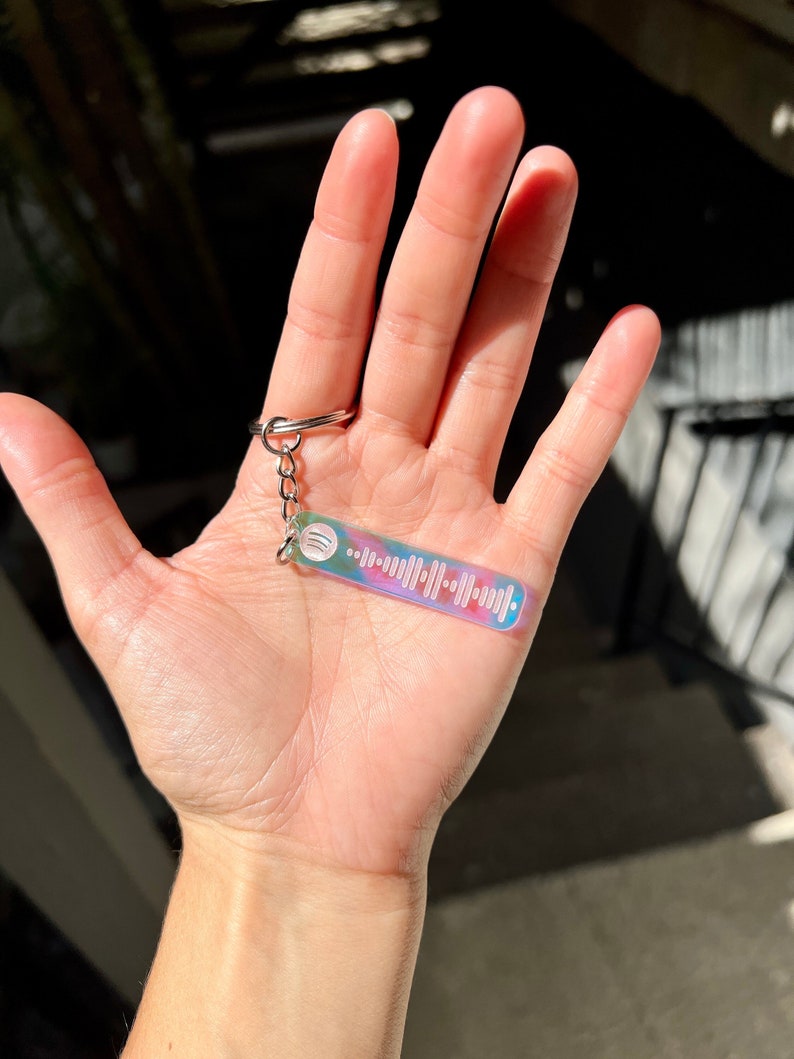 Personalized Spotify scan code keychain displayed on hand