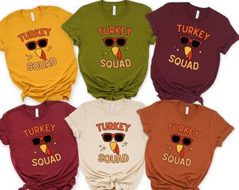 May include: Six t-shirts in different colors with a turkey wearing sunglasses and the text "Turkey Squad" printed on the front.