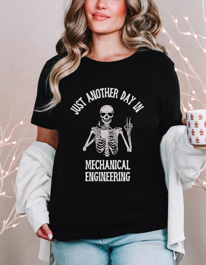 May include: Black t-shirt with a white skeleton holding a coffee cup and giving a peace sign. The text "Just another day in Mechanical Engineering" is printed on the shirt.