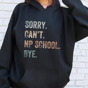 May include: Black hooded sweatshirt with the text "SORRY. CAN'T. NP SCHOOL. BYE." in a vintage style font.