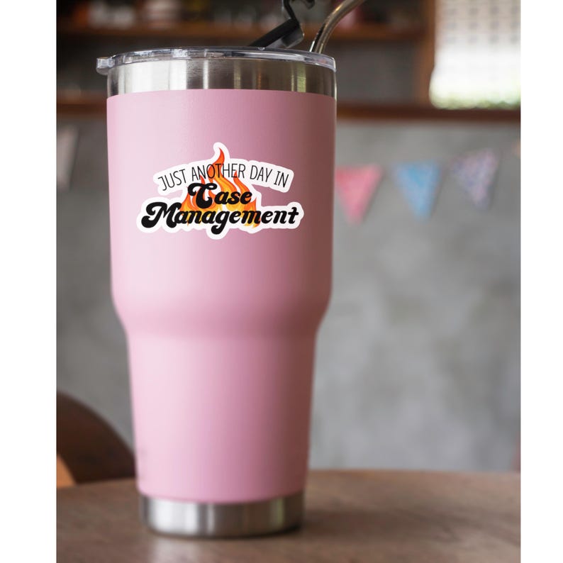 May include: Pink stainless steel travel mug with a white sticker that says "Just another day in Case Management" with a flame graphic.