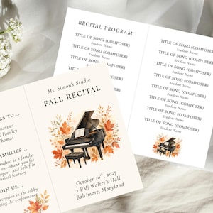 May include: A folded paper recital program featuring a watercolor illustration of a black grand piano surrounded by autumn leaves. The text reads Ms. Simon's Studio FALL RECITAL, October 10th, 2027, 2 PM, Walter's Hall, Baltimore, Maryland, and RECITAL PROGRAM.