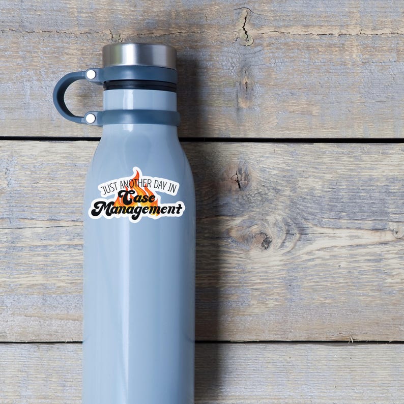 May include: A gray water bottle with a white sticker that says "Just another day in Case Management". The sticker has a flame design.