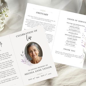 May include: A folded funeral programme titled Celebration of Life for Melissa Anne Taylor, featuring a portrait of an older person, floral accents, and an obituary. The interior panels display an Order of Service, a thank you note, and text.
