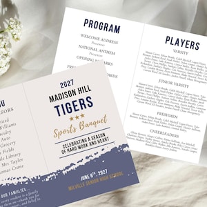 May include: A tri-fold sports banquet programme for the Madison Hill Tigers. The programme features a navy blue and gold colour scheme with the text "Sports Banquet" and the date "June 6th, 2027". The programme lists players and cheerleaders.