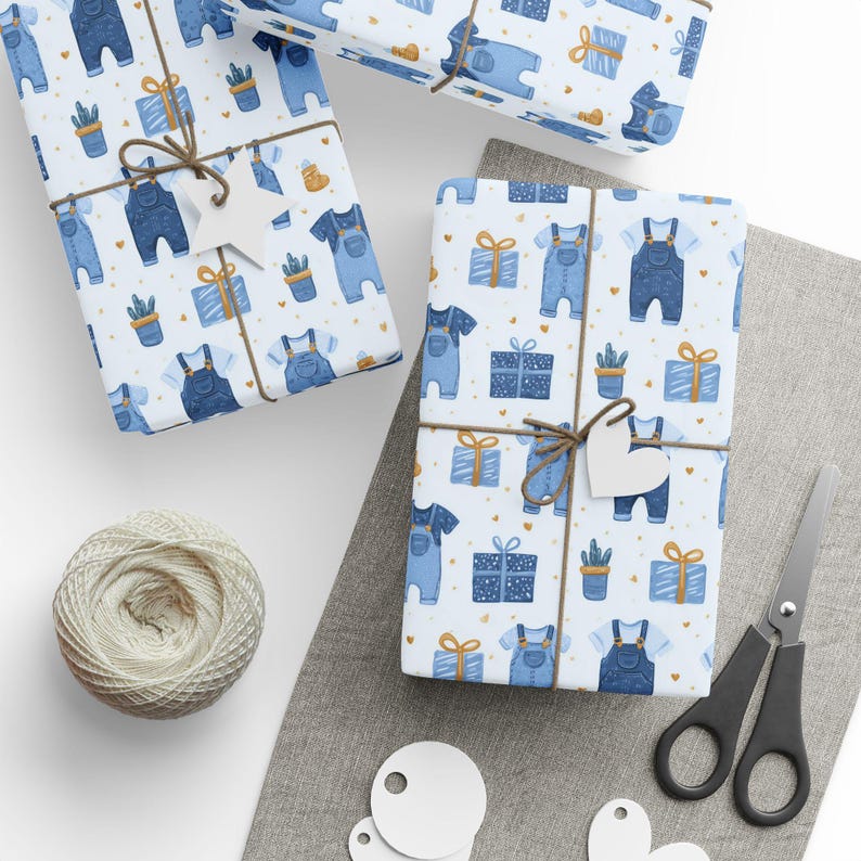 May include: Several wrapped gifts with a baby-themed pattern. The wrapping paper features blue overalls, gift boxes, and potted plants on a white background. Each present is tied with twine and a heart-shaped tag. A ball of twine, scissors, and blank tags are also visible.