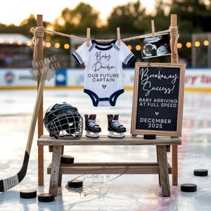 May include: A baby announcement featuring a hockey theme. A white onesie with navy trim hangs from a clothesline, with the text "Baby Davidson, Our Future Captain." A chalkboard sign reads "Breakaway Success! Baby Arriving at Full Speed, December 2025."