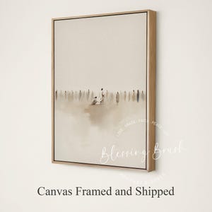 May include: Framed canvas art print with a minimalist design. The artwork features a neutral colour palette with a central group of figures and a crowd in the background. The canvas is set in a natural wood frame.