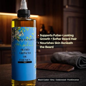 May include: An 8oz bottle of 12 Tribes On Earth Herbal Beard Growth Oil with a blue label. The text reads: Supports Fuller-Looking Growth + Softer Beard Hair, Nourishes Skin Beneath the Beard, and Black Castor, Emu, Cedarwood, Frankincense.