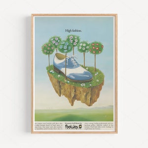 May include: A vintage advertisement for FootJoy golf shoes. The ad features a blue and white golf shoe floating on a small island with trees. The text reads "High fashion. Women's Golf Shoes by FootJoy."
