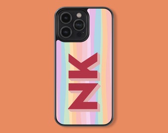 May include: A black phone case with a colorful striped pattern and the name "NIK" in red letters.
