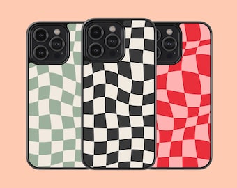 May include: Three phone cases with a checkered pattern. The cases are black with white checks, green with white checks, and red with white checks.