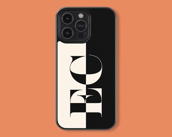 May include: Black and white phone case with a geometric design featuring the letters "EO".