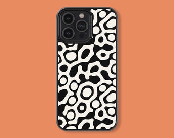 May include: A black and white patterned phone case. The case features a repeating abstract design of organic shapes in black against a cream background. The phone case has a black border and a camera cutout.